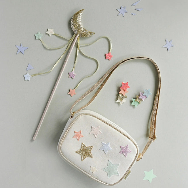 crossbody handbag beige bag with gold strap pastel metallic stars attached to it. picture shows matching stars clips and moon wand 