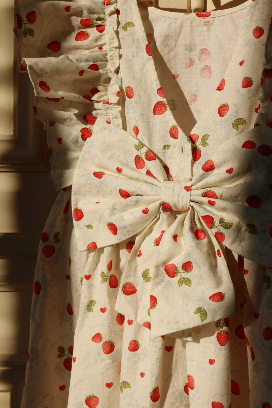 this picture is a picture of the dress with a big bow in the back in beautiful lighting. 