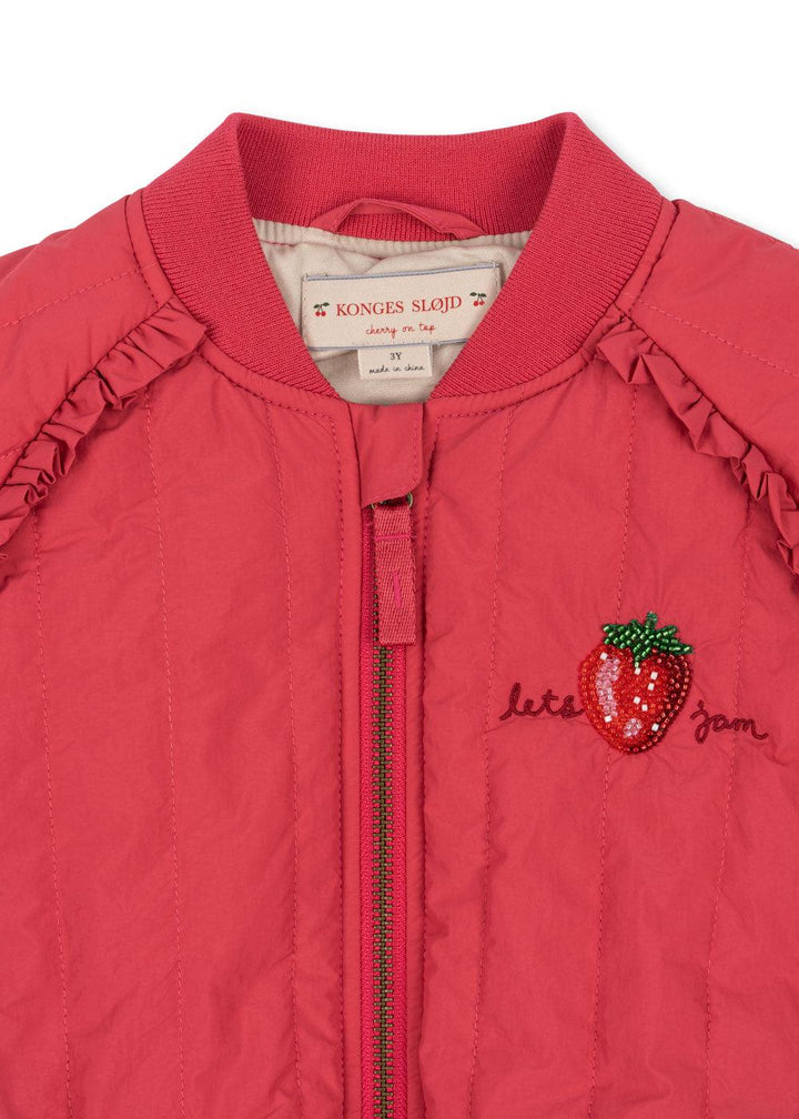 close up of beaded strawberry with "lets jam" written on the side of the strawberry. 