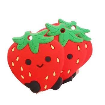100% Silicone Strawberry shaped teether. Strawberry is red with a smiley face
