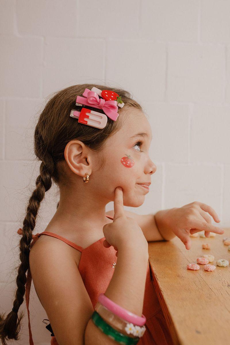 little girl modeling these alligator clips. showing the vibrant colors and substantial size of these clips. 