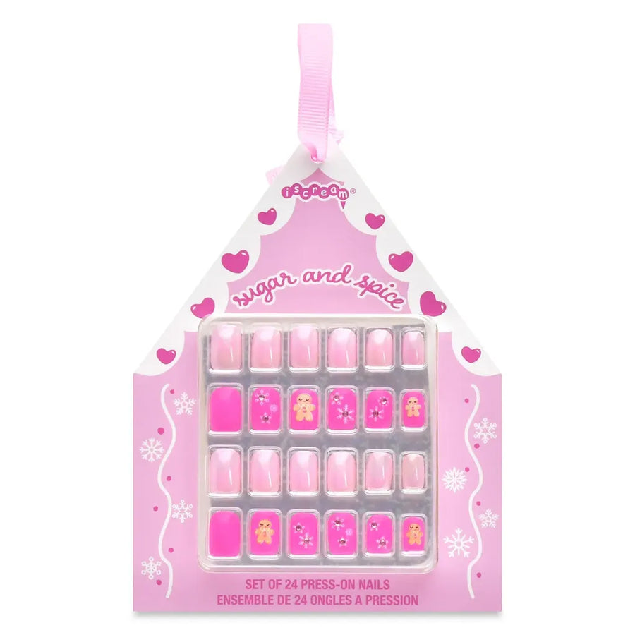 A pink house-shaped retail package containing a set of 24 press-on nails. The packaging is decorated with pink hearts, white swirls, and the text 'sugar and spice' and 'SET OF 24 PRESS-ON NAILS'.