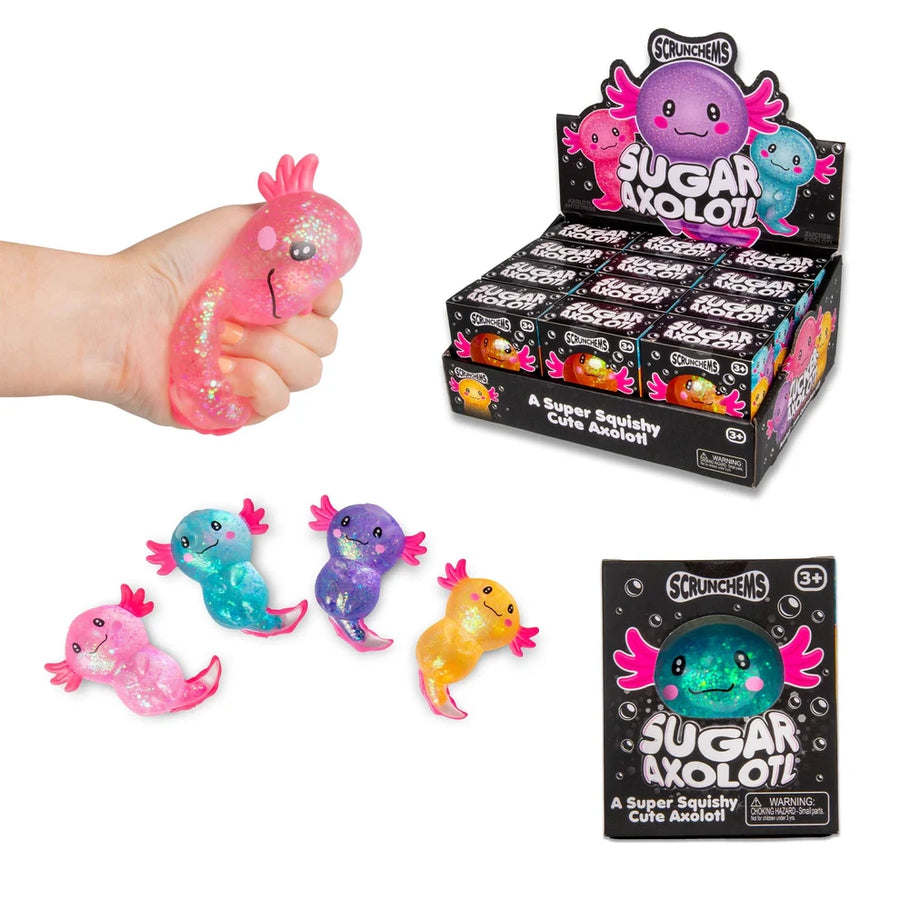 Sugar Axolotl squishy toys shown with a hand squeezing a pink glittery squishy, several small colorful axolotl figures, a display box of blind boxes, and a single box package on a white background.