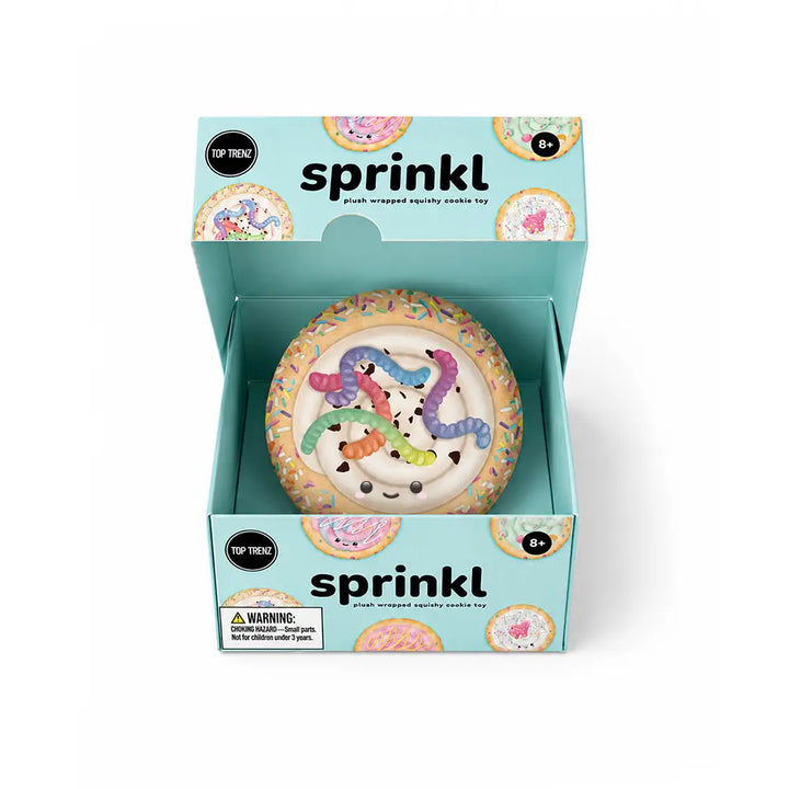 A packaged squishy toy shaped like a donut with colorful snake characters, shown inside an open mint-blue box labeled 'sprinkl'.