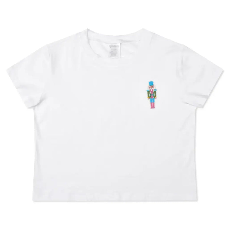 white tee with an embroidered nutcracker on the front 