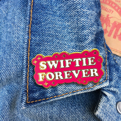 This picture shows the pin attached to a denim jacket. the pin adds the perfect pop to the look!