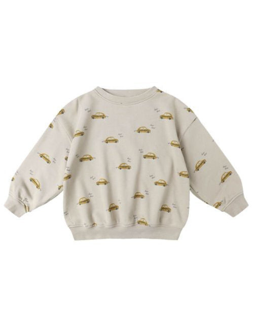 Beige sweatshirt with small taxi cab prints on a white background
