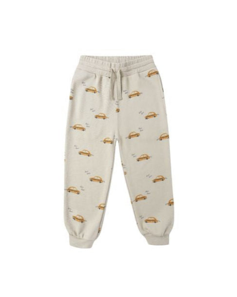 Beige sweatpants with taxi patterns on a white background