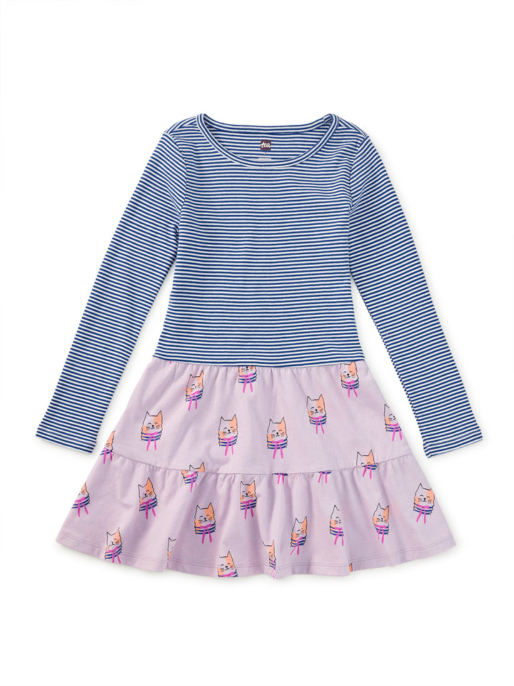 Children's dress with blue striped top and purple skirt with cat pattern on a white background