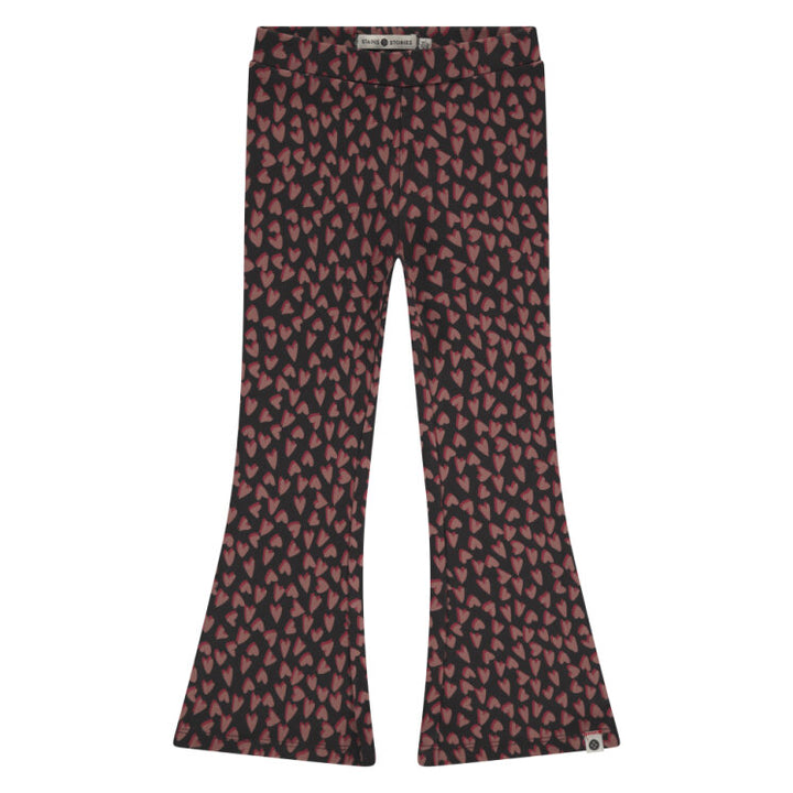 Flared pants with a red and black pattern on a white background