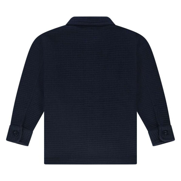 back of Navy blue textured shirt on a white background