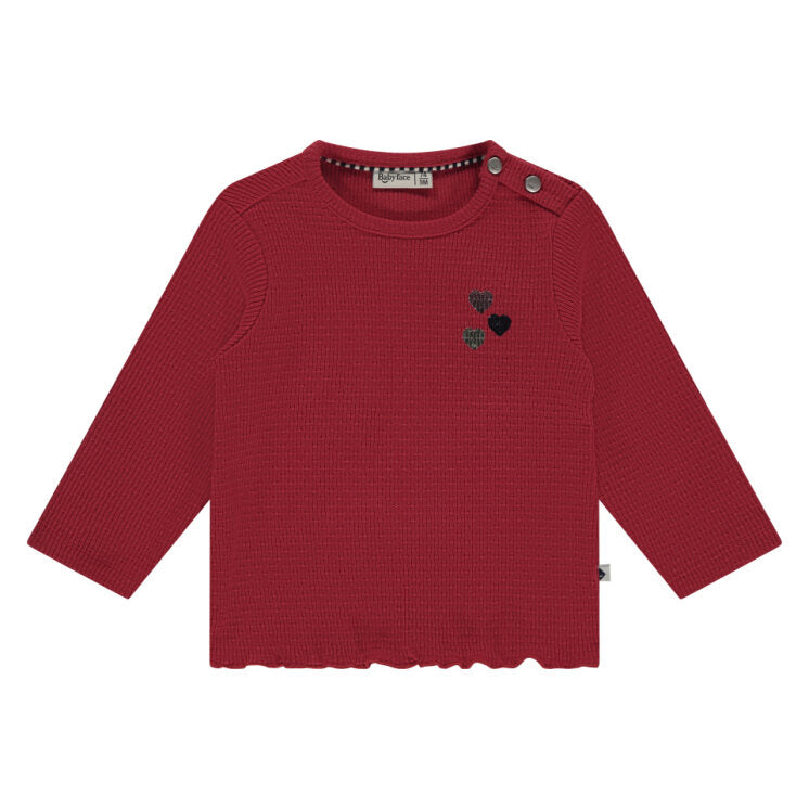 Red long-sleeve shirt with embroidered details on a white background