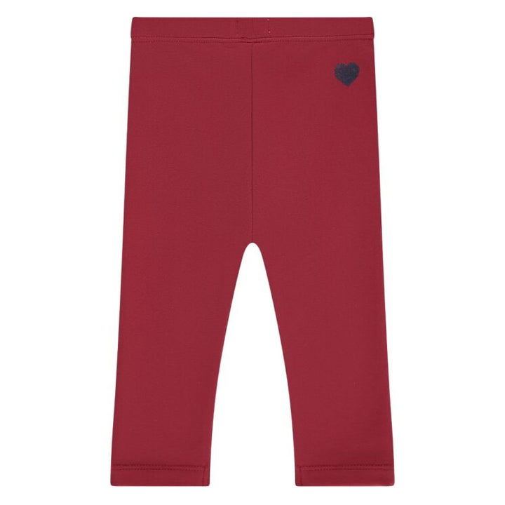 Red leggings with a heart-shaped logo on a white background