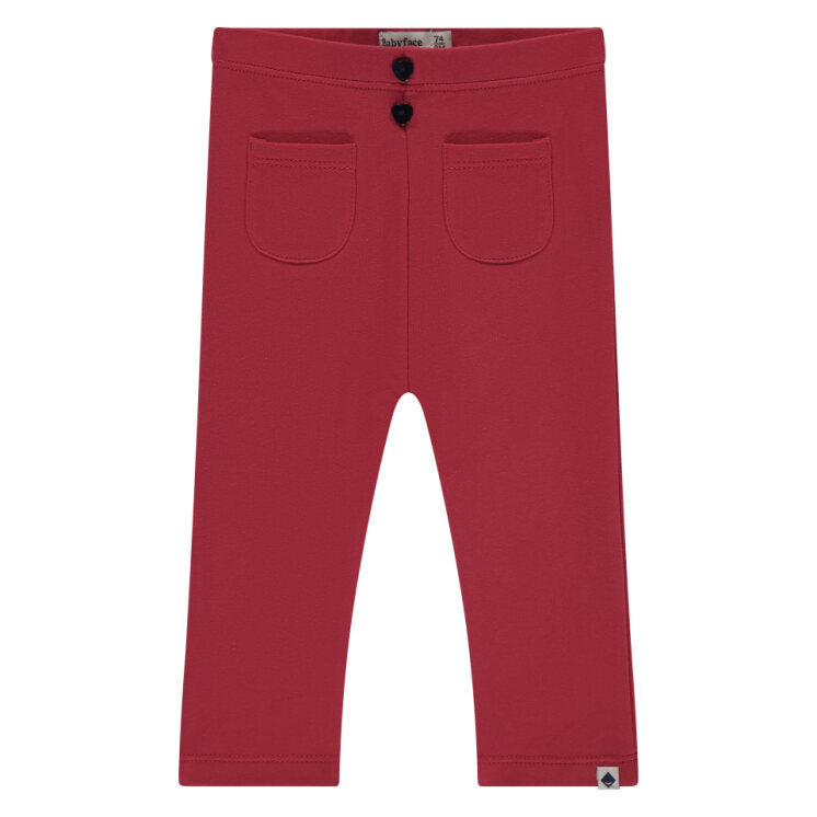 Red pants with two front pockets on a white background