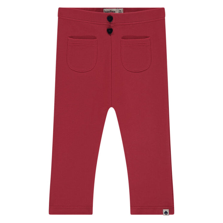 Red pants with two front pockets on a white background