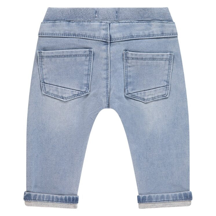 Back view of light blue denim jeans on a white background