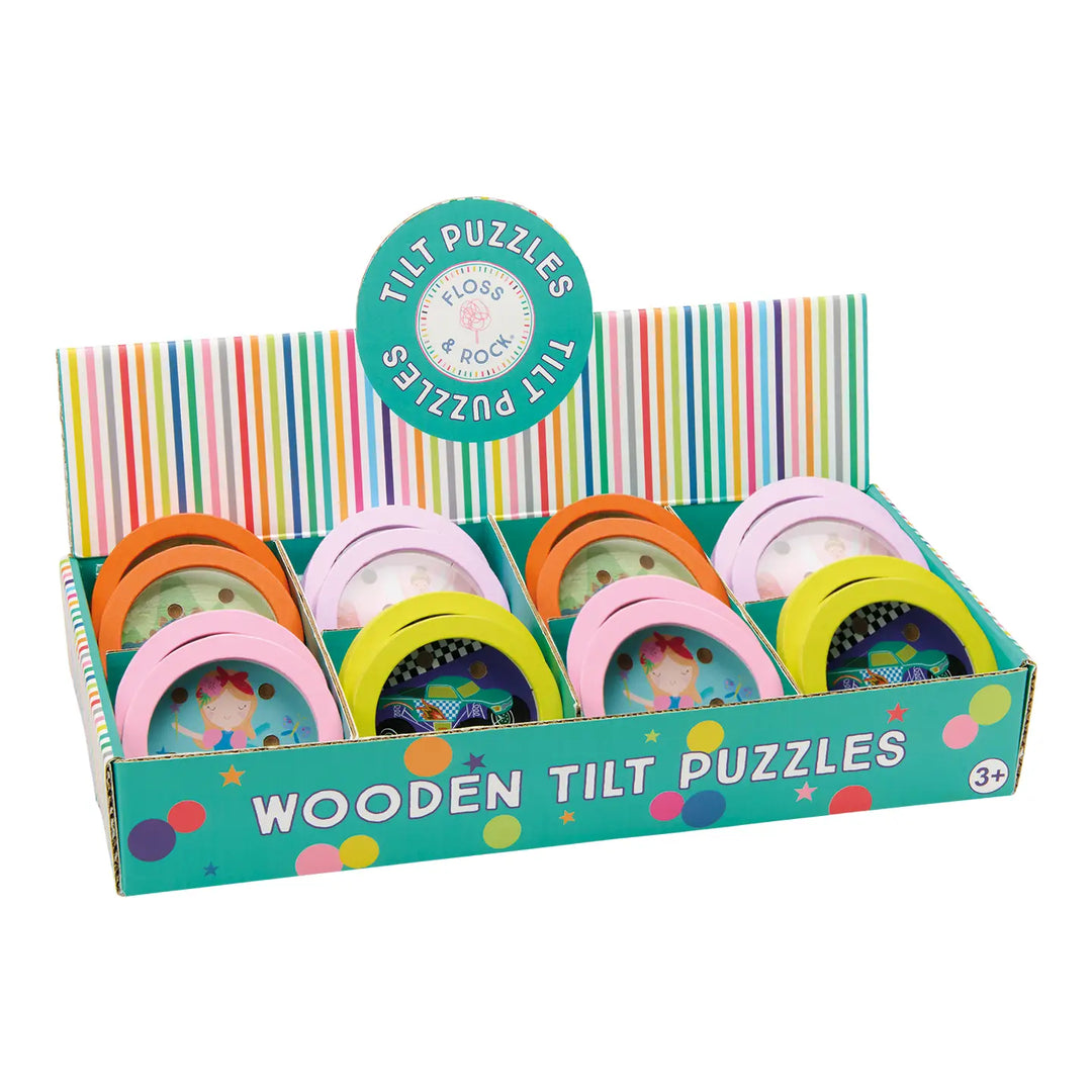 A retail display box of Plofter Wooden Tilt Puzzles, featuring six colorful wooden puzzle hoops in pink, orange, yellow, and green, set against a clean white background.