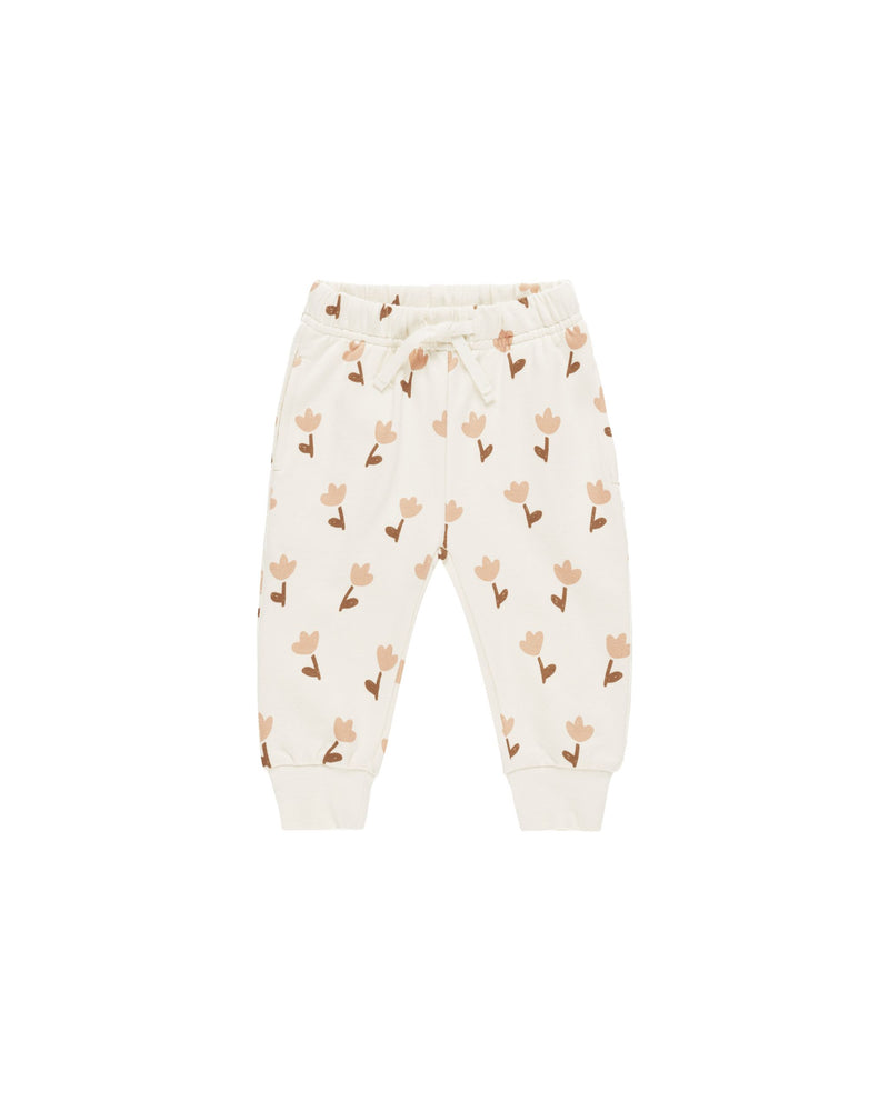 relaxed joggers, beige base color with dusty rose tulips and taupe stems and leaves print all over. 