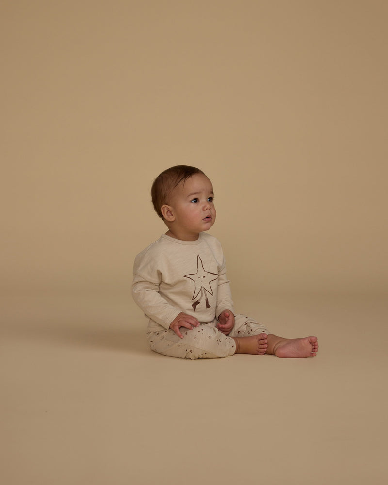 baby modeling the twinkle set, tan star on the shirt and tiny little stars all over the pants. 