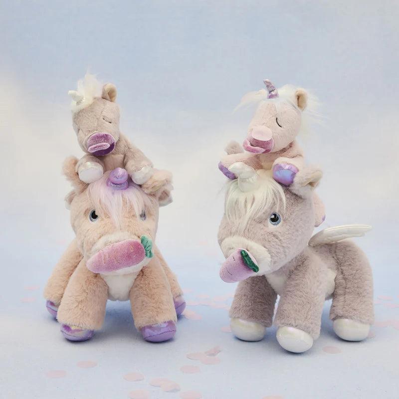 big pink and lavender unicorns with baby unicorns sitting atop their heads. 