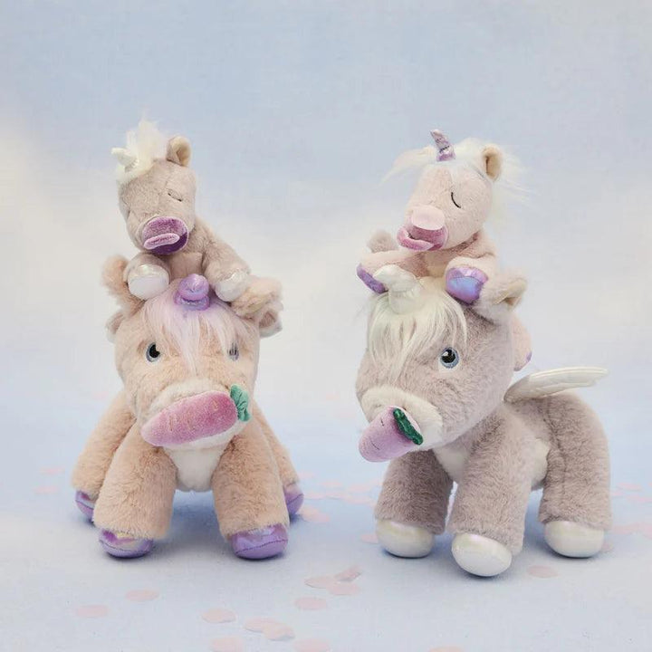 big pink and lavender unicorns with baby unicorns sitting atop their heads. 