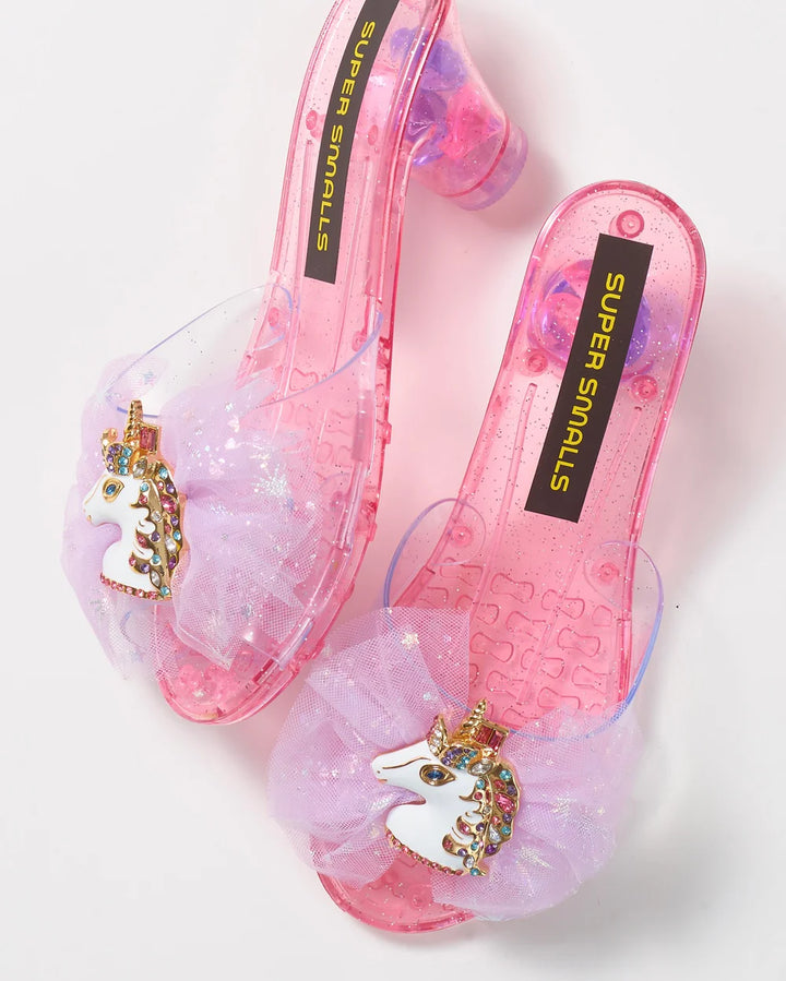 play shoes with enamel unicorn clips on a pink slip on heel with a tulle bow