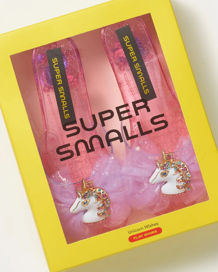 pink slip on heels with a unicorn enamel pin and a pink tulle bow at the front. 
