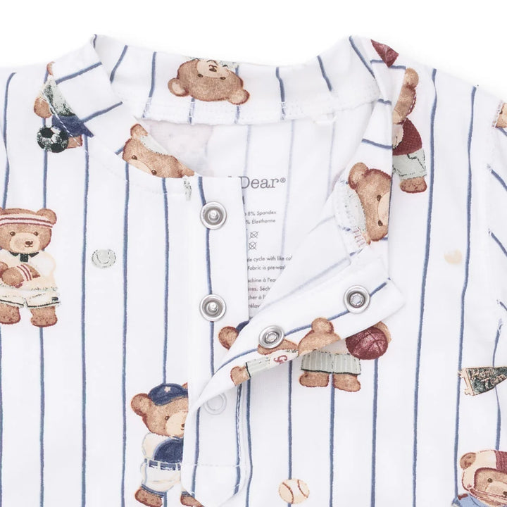 Children's romper with teddy bear pattern and buttons on a white background