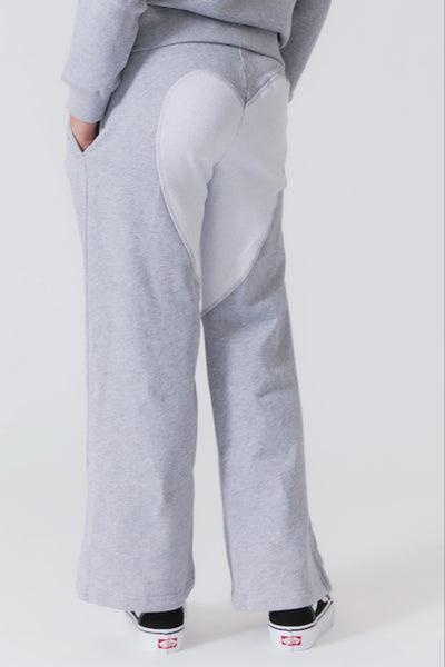 Girl is wearing matching wide leg sweatpant with hearts embroidered on back of wide leg sweat pant.