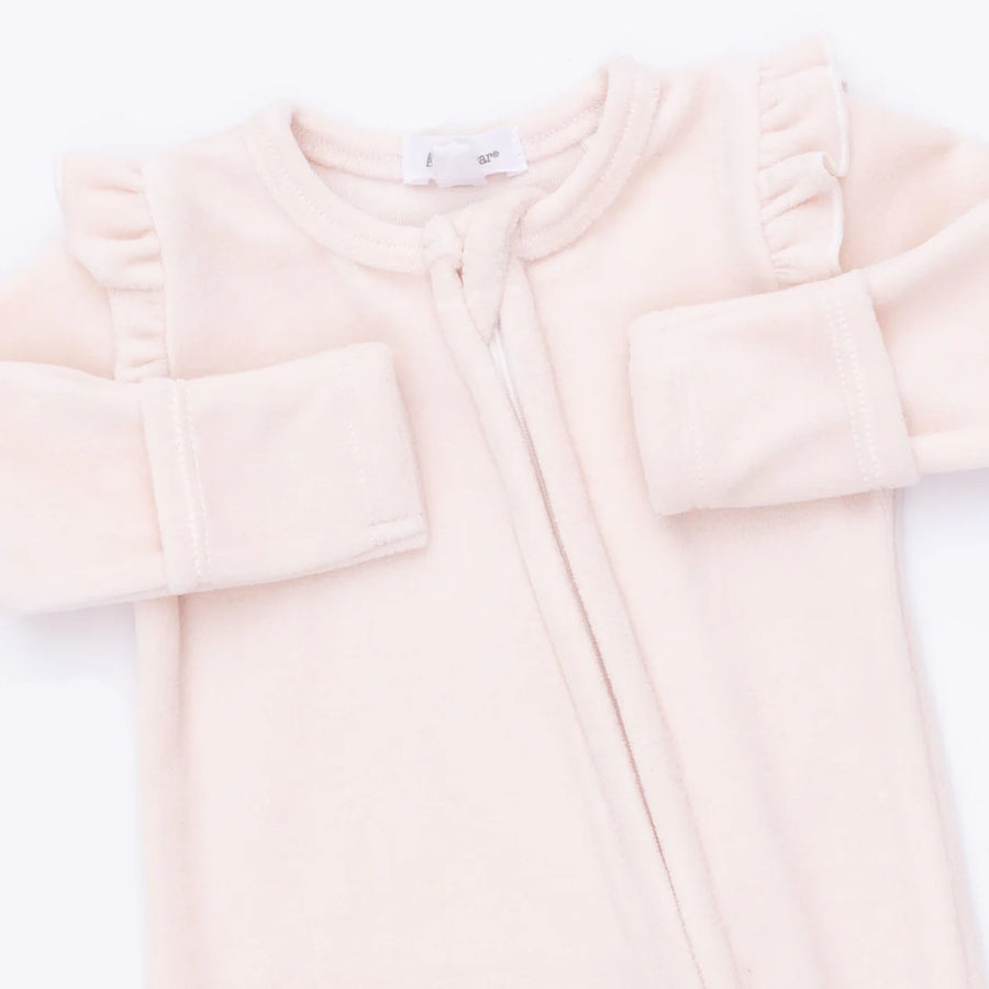 A pale pink baby footie with long sleeves, ruffled shoulder details, and a front zipper, shown on a plain white background.