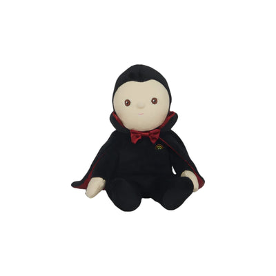 Vincent sitting along modeling his fancy black cloak and red bowtie. 