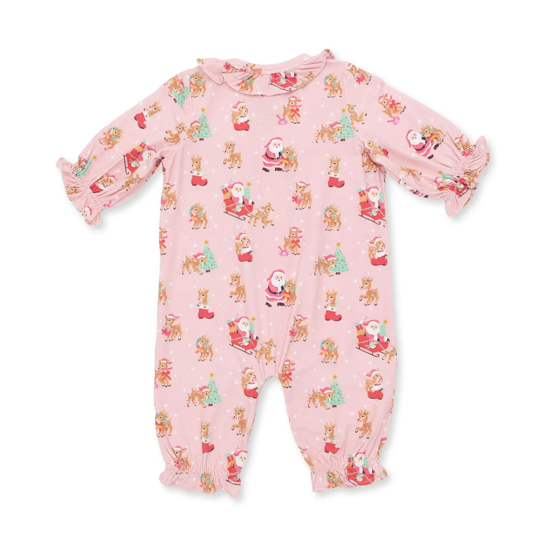 A pink baby footed one-piece jumpsuit with a festive Christmas print featuring Santa Claus, reindeer, and snowflakes, displayed flat against a white background.