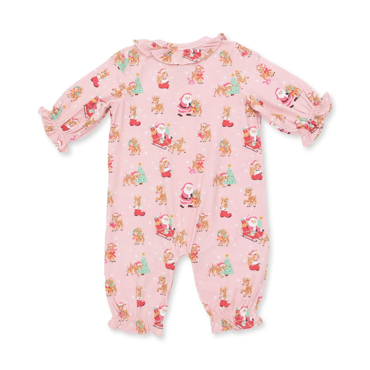 A pink baby footed one-piece jumpsuit with a festive Christmas print featuring Santa Claus, reindeer, and snowflakes, displayed flat against a white background.