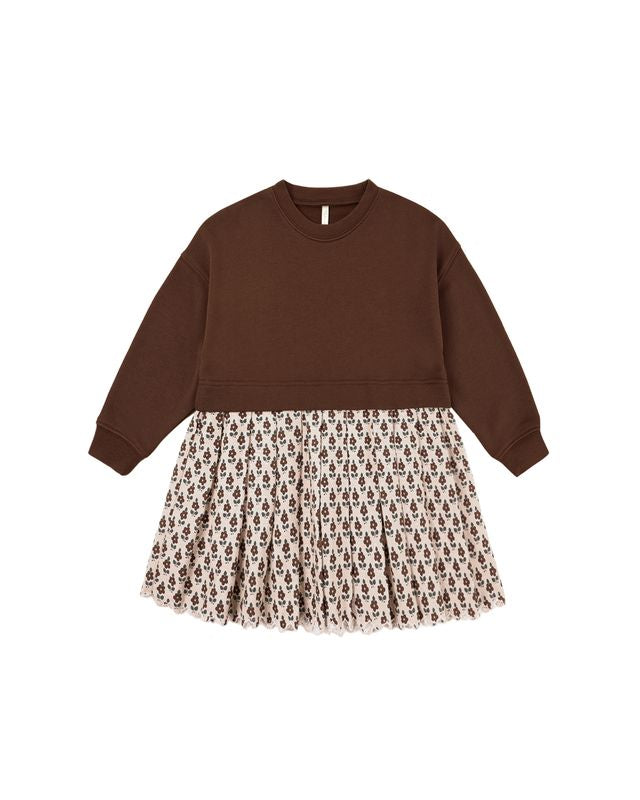 Brown sweater dress with patterned skirt on a white background