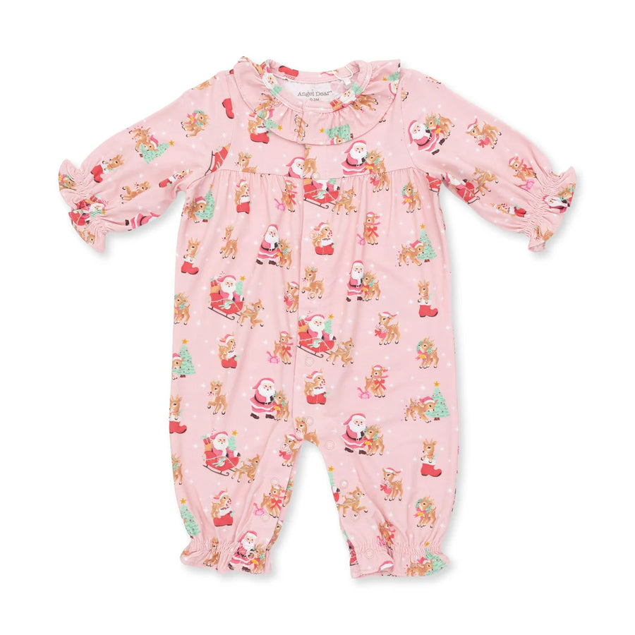 A baby's long-sleeve footless one-piece jumpsuit in light pink, featuring an all-over Christmas print of Santa Claus, reindeer, and Christmas trees. The garment has ruffled trim at the collar, cuffs, and ankles, and is photographed flat against a solid white background.
