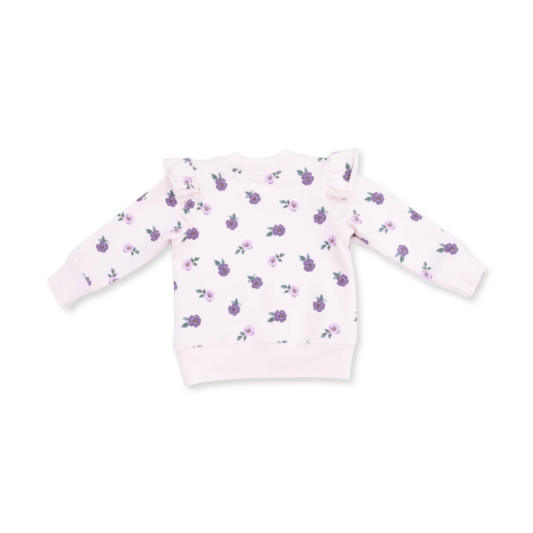 A light pink long-sleeve sweatshirt for toddlers, featuring an all-over print of small purple flowers with green leaves and ruffled details on the shoulders, shown against a plain white background.