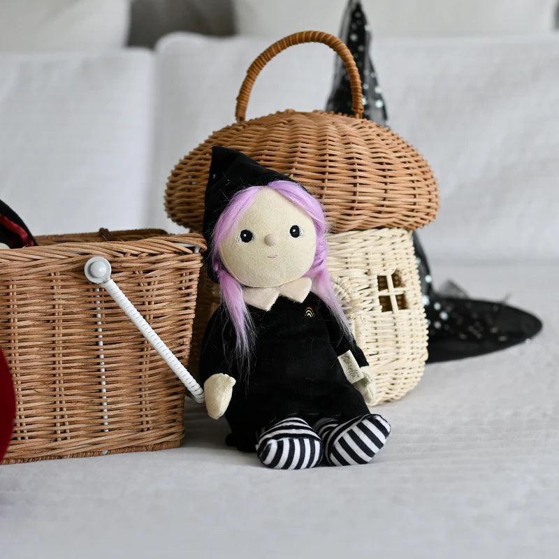 willa witch doll with black hat and lavender hair. black and white striped socks and black dress with white collar. 