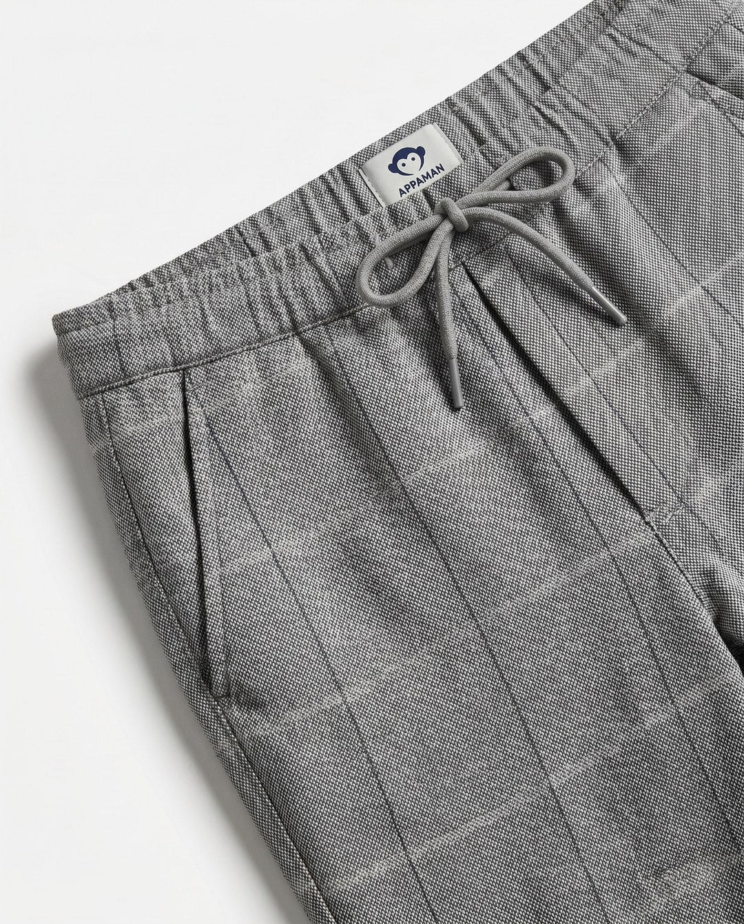 close up of the color and texture of the pants fabrication. gray with a slight windowpane