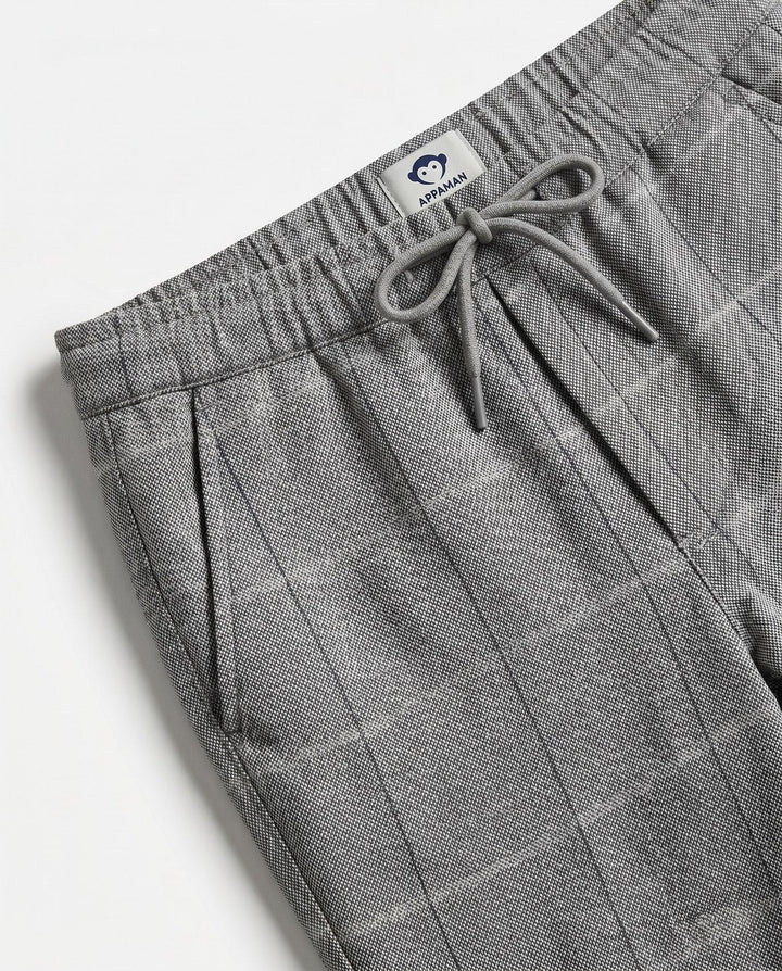 close up of the color and texture of the pants fabrication. gray with a slight windowpane