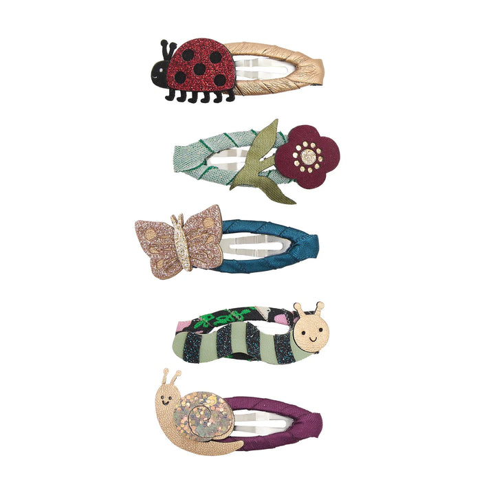 Set of five decorative hair clips shaped like a ladybug, flower, butterfly, caterpillar, and snail on a white background.