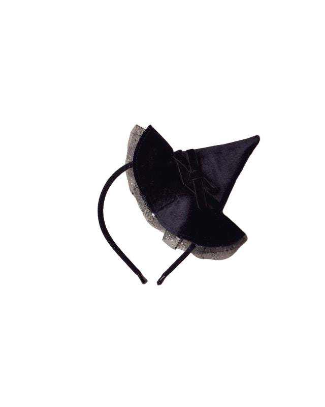 Black headband with decorative witch hat on a beige background