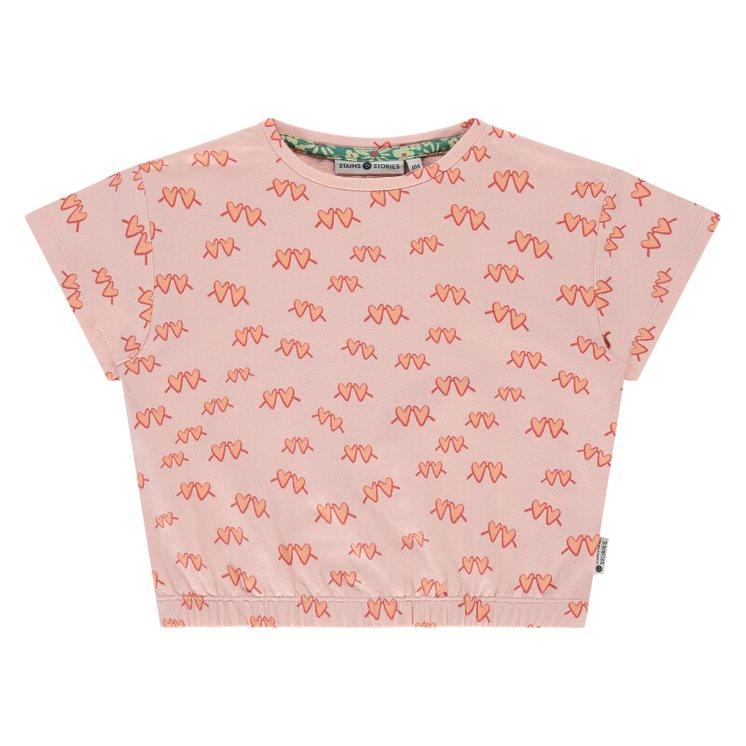 pink short sleeve t-shirt with coral sunglasses in the shape of hearts. elastic at the bottom of the shirt. 