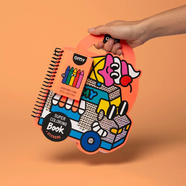 hand holding a coloring book shaped like an ice cream truck 