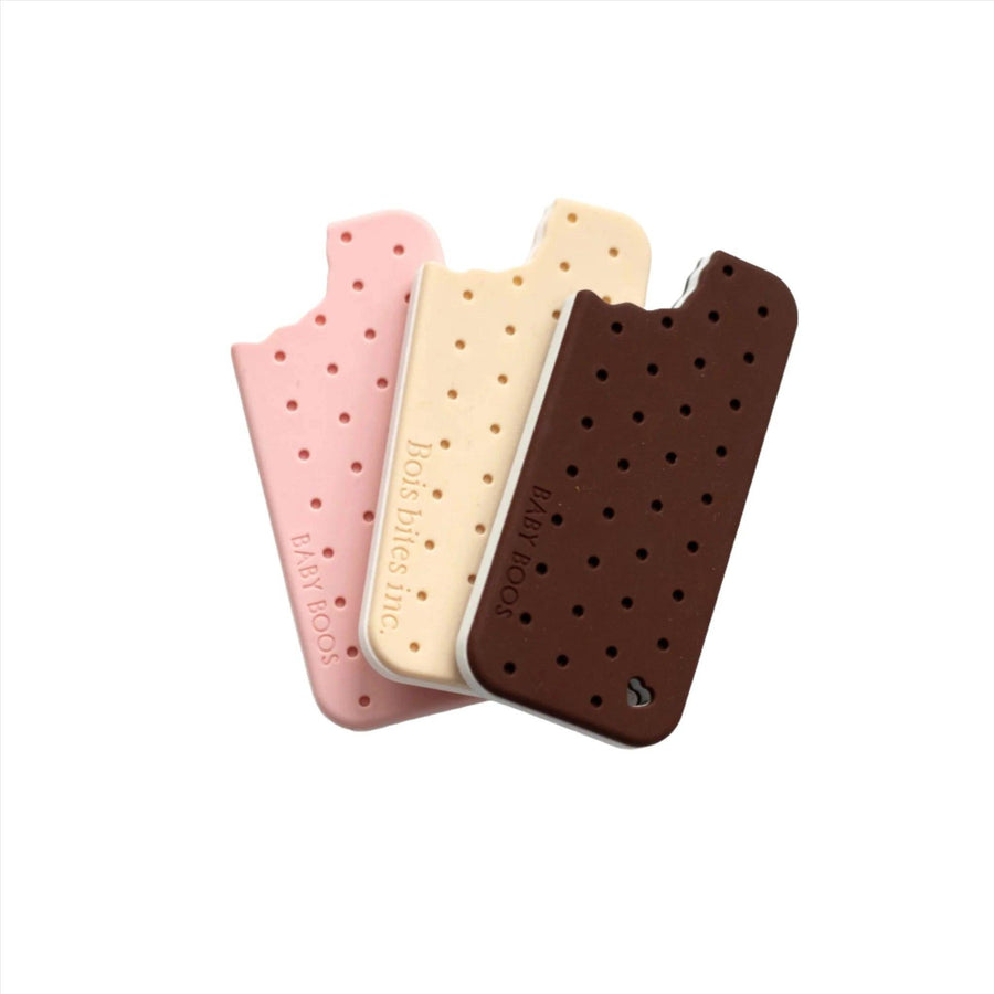 silicone teether shaped like an old fashioned ice cream sandwich in the chocolate, vanilla and strawberry flavors.