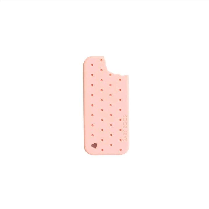 Silicone Teether shaped like an old fashioned ice cream sandwich in a strawberry flavor with a little bite on top of it. 