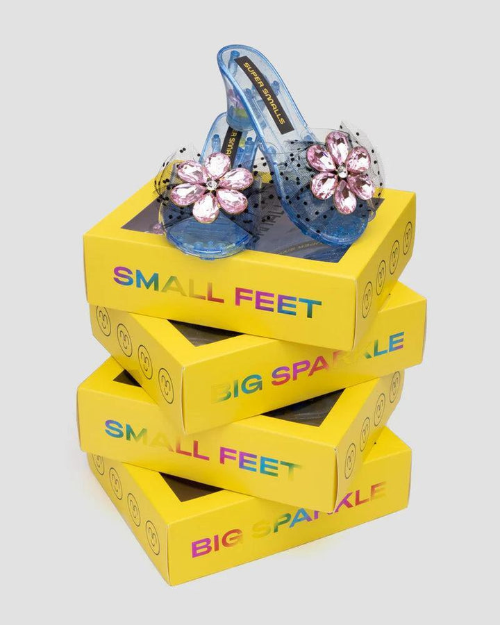 stacks of super smalls packaging with the play shoes sitting on top on display.