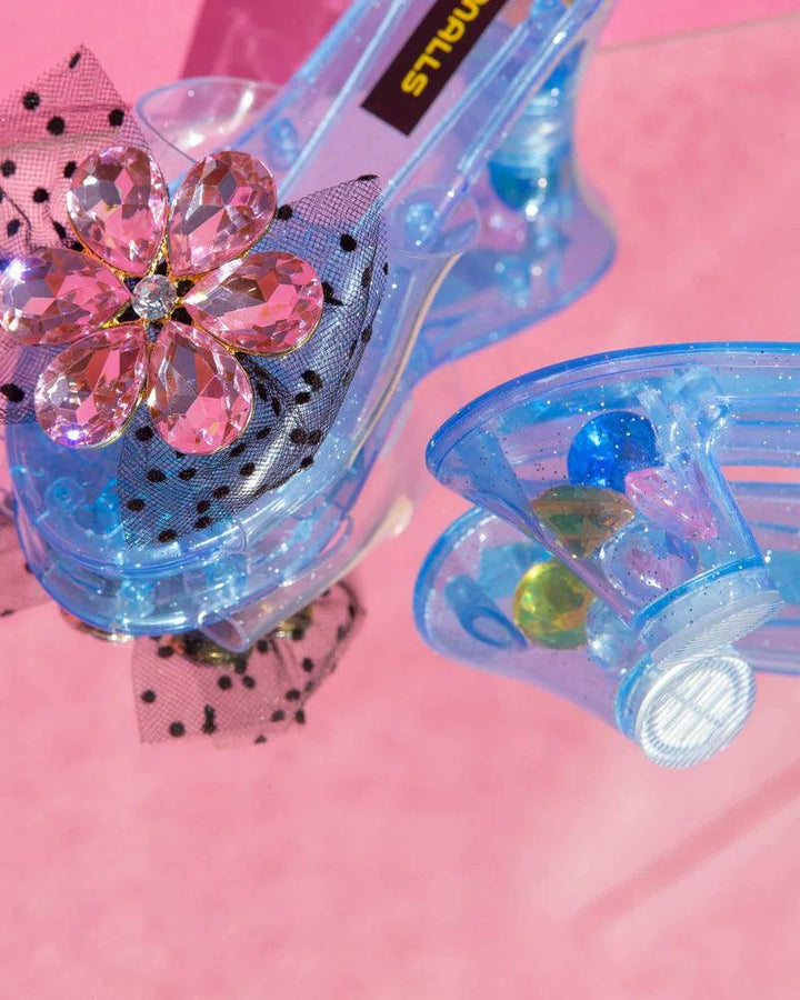 close up of the dress up shoes with blue base and pink flower rhinestone gem and black tulle bow. this also shows the heel and how there are stones in the heel for added drama