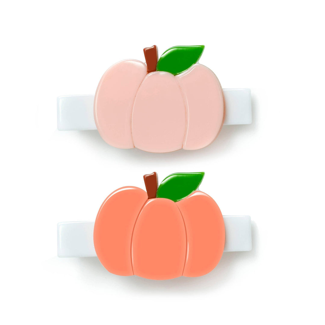 set of 2 alligator clips one peach pumpkin on a white alligator clip and one orange pumpkin on a white alligator clip