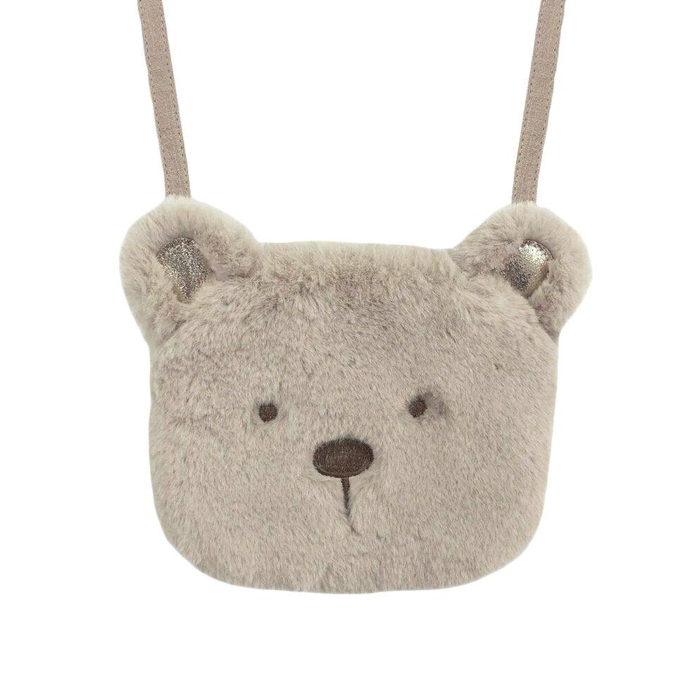 crossbody bag in the shape of a teddy bear head. teddy is fluffy attached to a tan strap