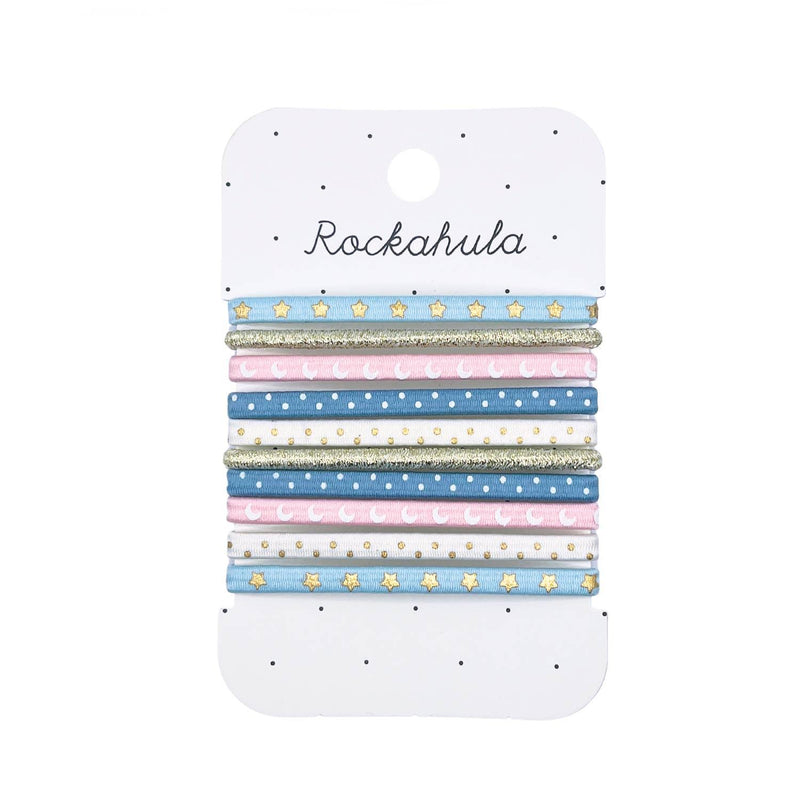 pack of hair ties with printed moons, stars and polka dots on them. Light blu, white, light pink and gold